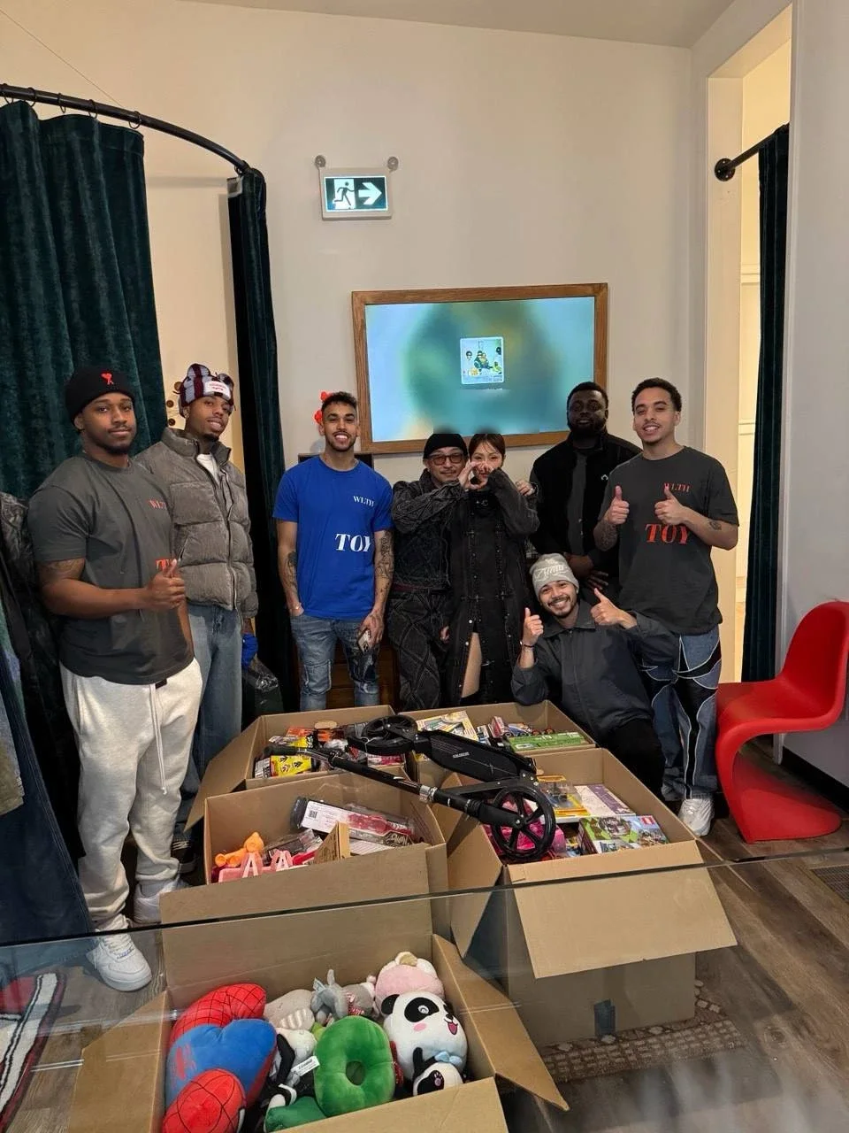 The WLTH crew in Toy Drive tees with boxes of donated toys